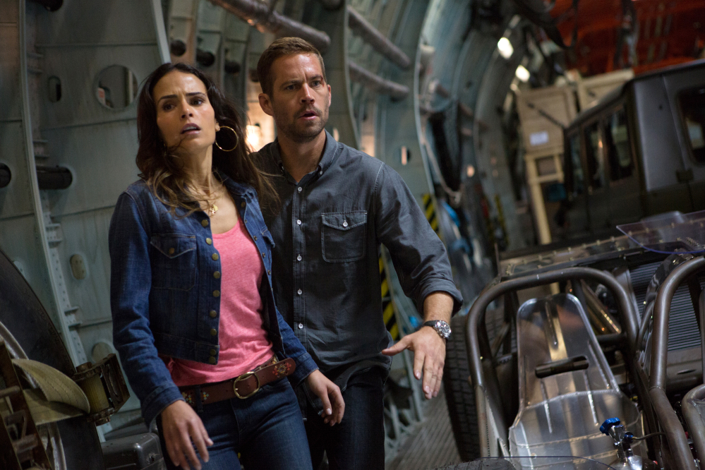 This publicity image shows Jordana Brewster, left, and Paul Walker in a scene from “Fast & Furious 6.” Shooting on “Fast & Furious 7” was about midway through when the 40-year-old Walker died in a car crash outside of Los Angeles.