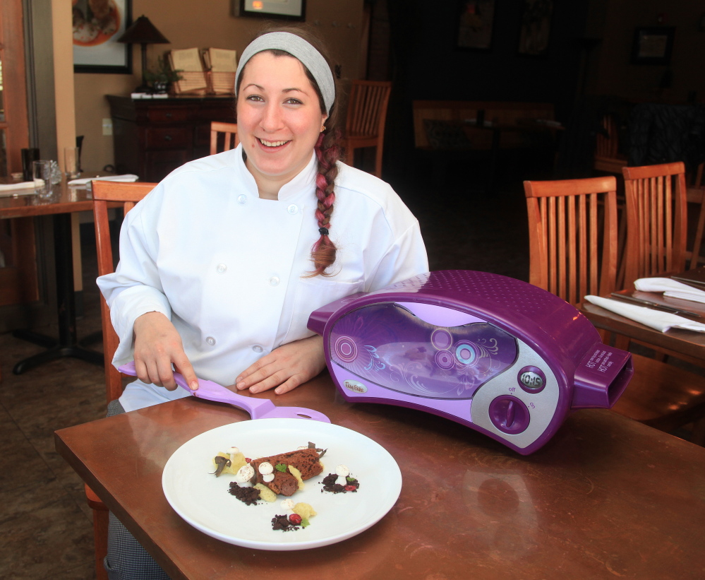 Addie Davis, executive pasty chef at 555 on Congress Street in Portland, with her gingerbread buche de Noel that she created with an Easy-Bake Oven.