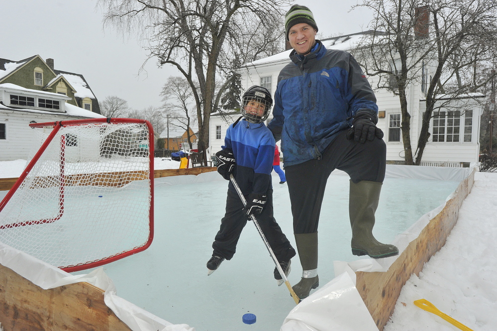 Gibson Fay-Leblanc and his son Liam enjoy the skating rink that Fay-Leblanc built in the backyard of his Portland home for his two sons.