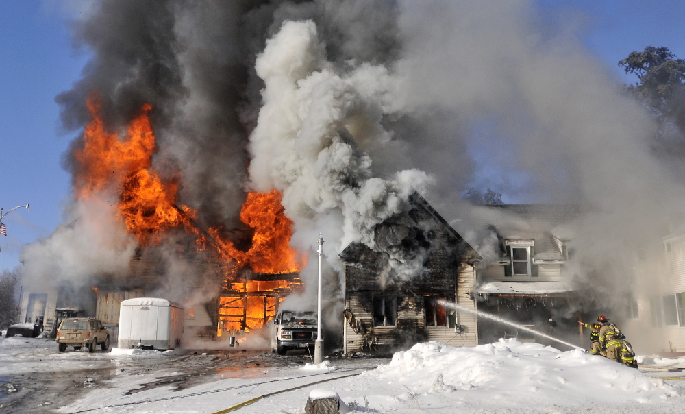 Firefighters from Waterville battle a blaze at 160 Drummond Ave. in Waterville on Wednesday.