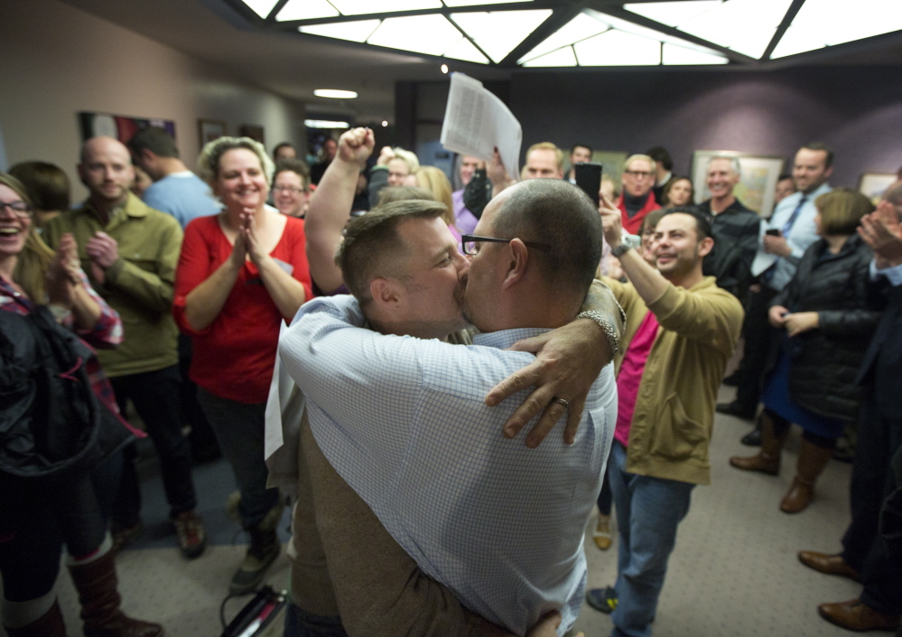 Chris Serrano, left, and Clifton Webb kiss after being married in Salt Lake City last Friday. Judges in Utah, New Mexico and Ohio have all ruled in favor of gay marriage recently.