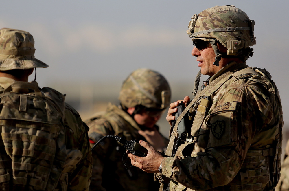 Sgt. Todd Mills of Gorham, who traded his portfolio manager suit and tie for fatigues and body armor, prepares Thursday for battle drills with the 133rd Engineer Battalion in Afghanistan.