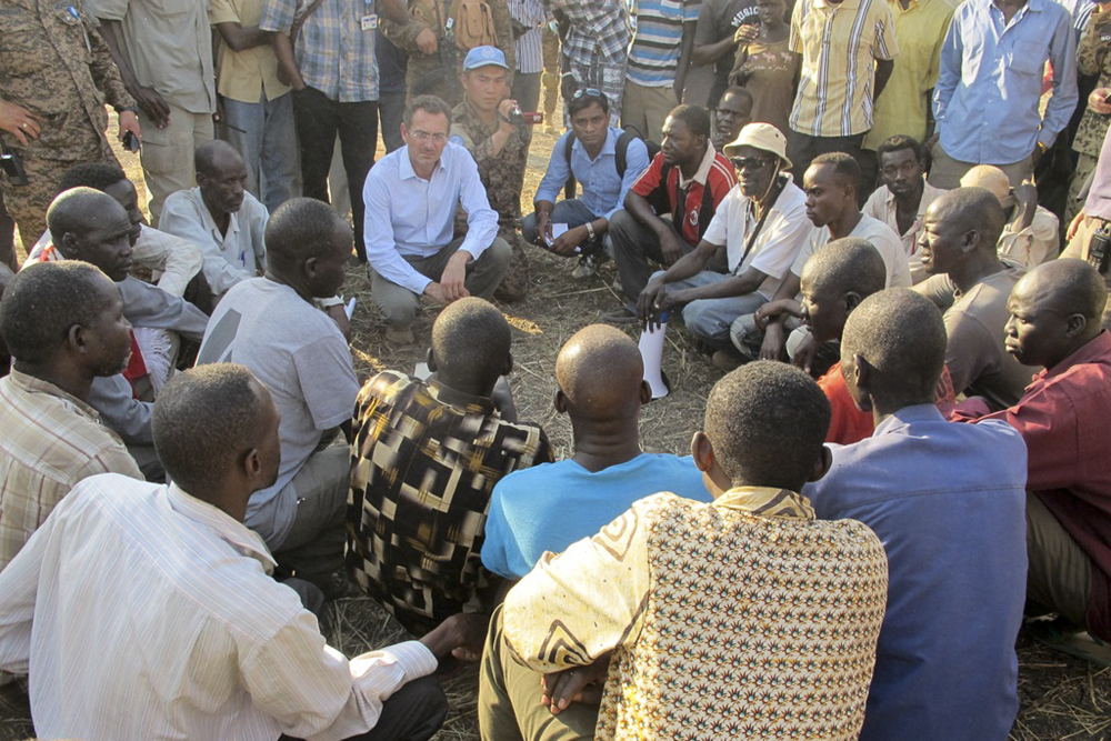 U.N. humanitarian official Toby Lanzer, center-left, visits the U.N. compound where many displaced people have sought shelter in Bentiu, South Sudan, this week.