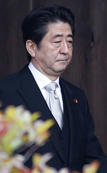 Japanese Prime Minister Shinzo Abe walks into Yasukuni Shrine in Tokyo on Thursday.