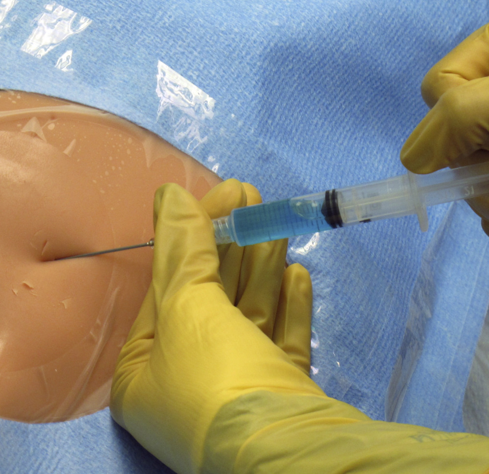 Dr. Jothi Kanagalingam practices the new technique for catheter insertion on a mannequin at Fletcher Allen Health Care in Burlington, Vt., on Dec. 11.