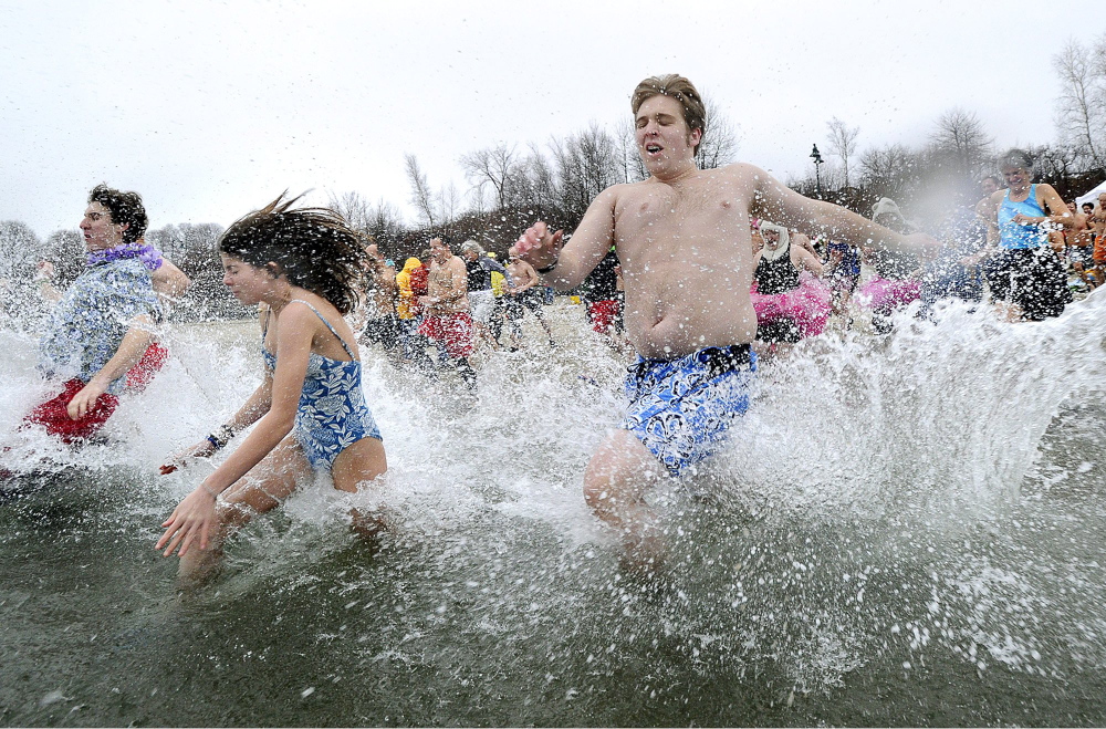 About 100 people participated in the annual Polar Bear Plunge at the East End Beach in Portland on Dec. 31, 2011.