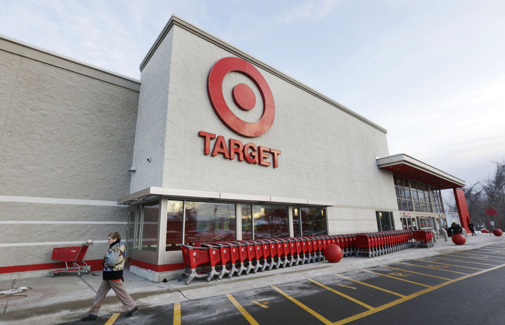 A passer-by walks near an entrance to a Target retail store in Watertown, Mass., this month. Target on Friday said customers’ encrypted PIN data was removed during the data breach that occurred earlier this month. But the company says it believes the PIN numbers are still safe because the information was strongly encrypted.