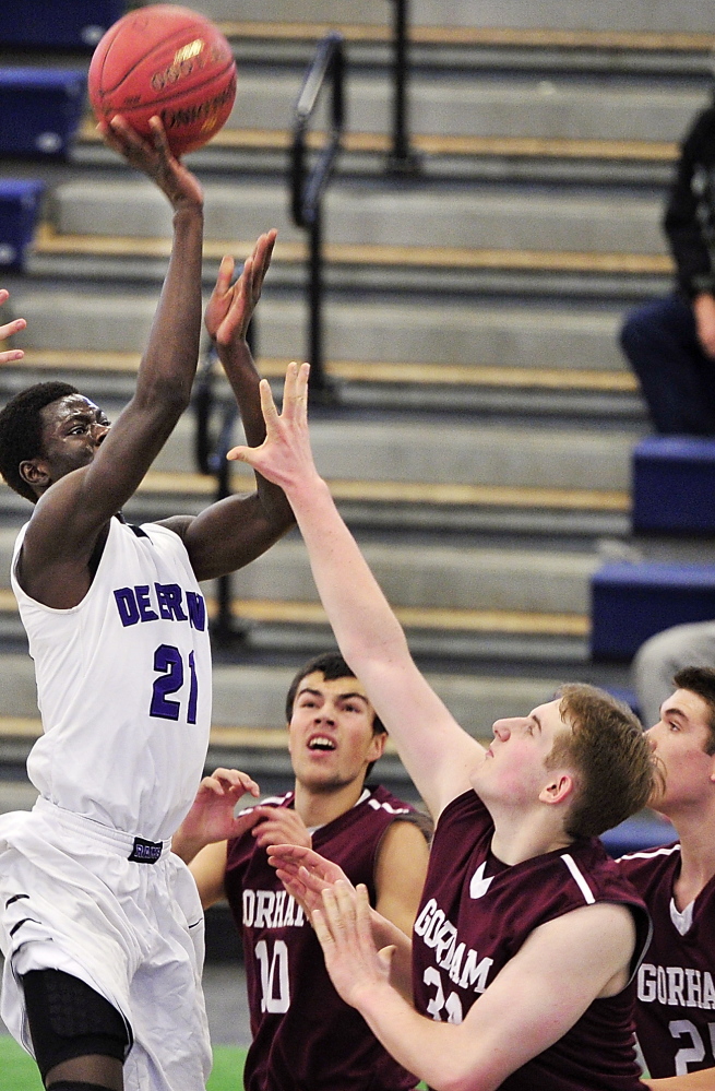 Ahmed Ismail Ahmed of Deering gets his shot off over the Gorham defense Friday night during Deering’s 77-51 victory at the Portland Expo – a regular-season game in a holiday tournament.