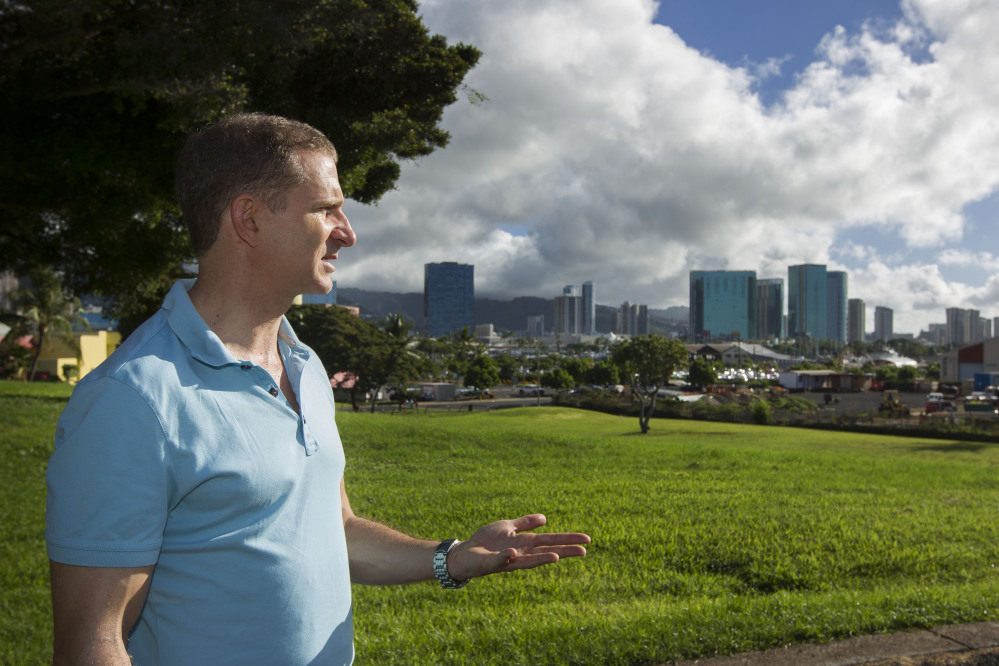 Robert Perkinson, an associate professor at the University of Hawaii at Manoa, talks about the possible location in the Kakaako district of Honolulu to be considered for the Barack Obama Presidential Library in Honolulu. The plot of land can be seen to the far right.