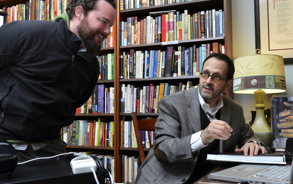 Photographer Gregory Heisler, right, chats with Paul Murphy as he signs a copy of his first book on his craft, “Gregory Heisler: 50 Portraits: Stories and Techniques From a Photographer’s Photographer,” in Easthampton, Mass.