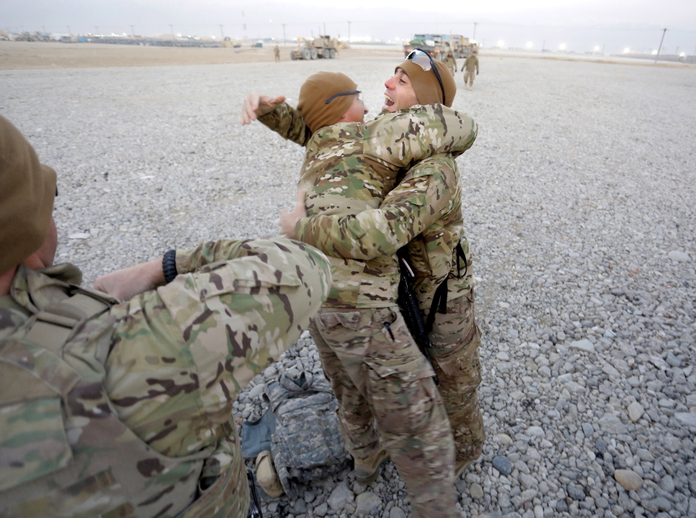 Sgt. 1st Class Kameel Farag of Oakland, right, welcomes 1st Sgt. Andrew Pattle of Harrison and other members of the Convoy Escort Team back to Bagram Air Field on Dec. 24.