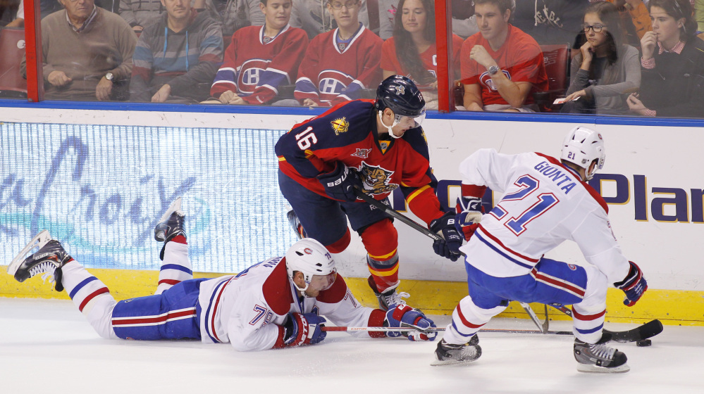 Florida Panthers center Aleksander Barkov battles against Montreal Canadiens defenseman Andrei Markov, left, and right wing Brian Gionta during the first period of Sunday’s game in Sunrise, Fla., won by the Panthers, 4-1.