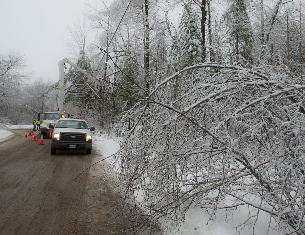 A crew sets up to restore power near Brewer Lake in Orringtonon Sunday. Bangor Hydro line crews working with Asplundh Tree Service crews have been in the King's Mountain area of Orrington since Dec. 26.