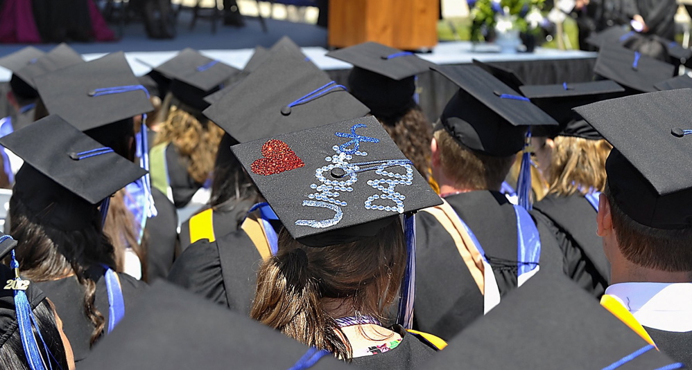 A senior sends a message to her parents during the 2012 graduation ceremonies at Saint Joseph’s College. A new survey aims to figure out what people get out of college, in both tangible and intangible ways.