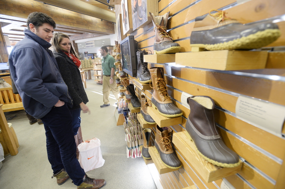 Ian Rothkopf and Jaci Daigneault, both of Boston, look over boots while shopping Monday at L.L. Bean in Freeport. Several popular sizes are out of stock because of the harsh winter.