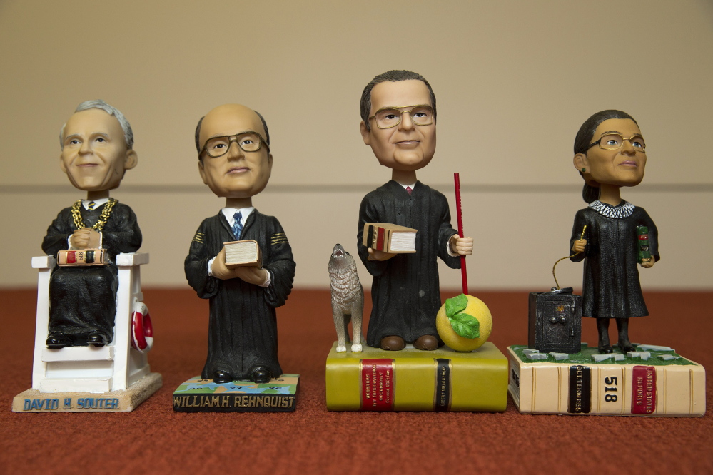 Bobblehead figures representing Supreme Court justices, from left, David Souter, William Rehnquist, Antonin Scalia and Ruth Ginsburg, are shown in a Nov. 20 photo. Given away, not sold, they are treasured by the justices and coveted by fans.