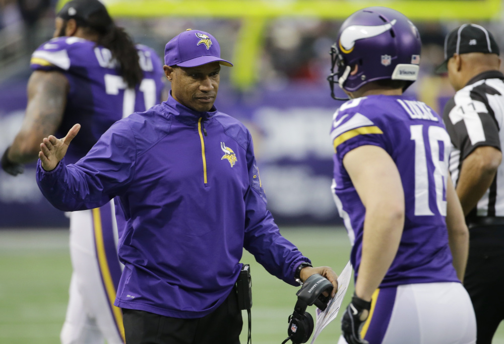 Minnesota Vikings head coach Leslie Frazier, left, reacts with punter Jeff Locke during the first half of an NFL football game against the Detroit Lions on Sunday in Minneapolis. The Vikings won 14-13.