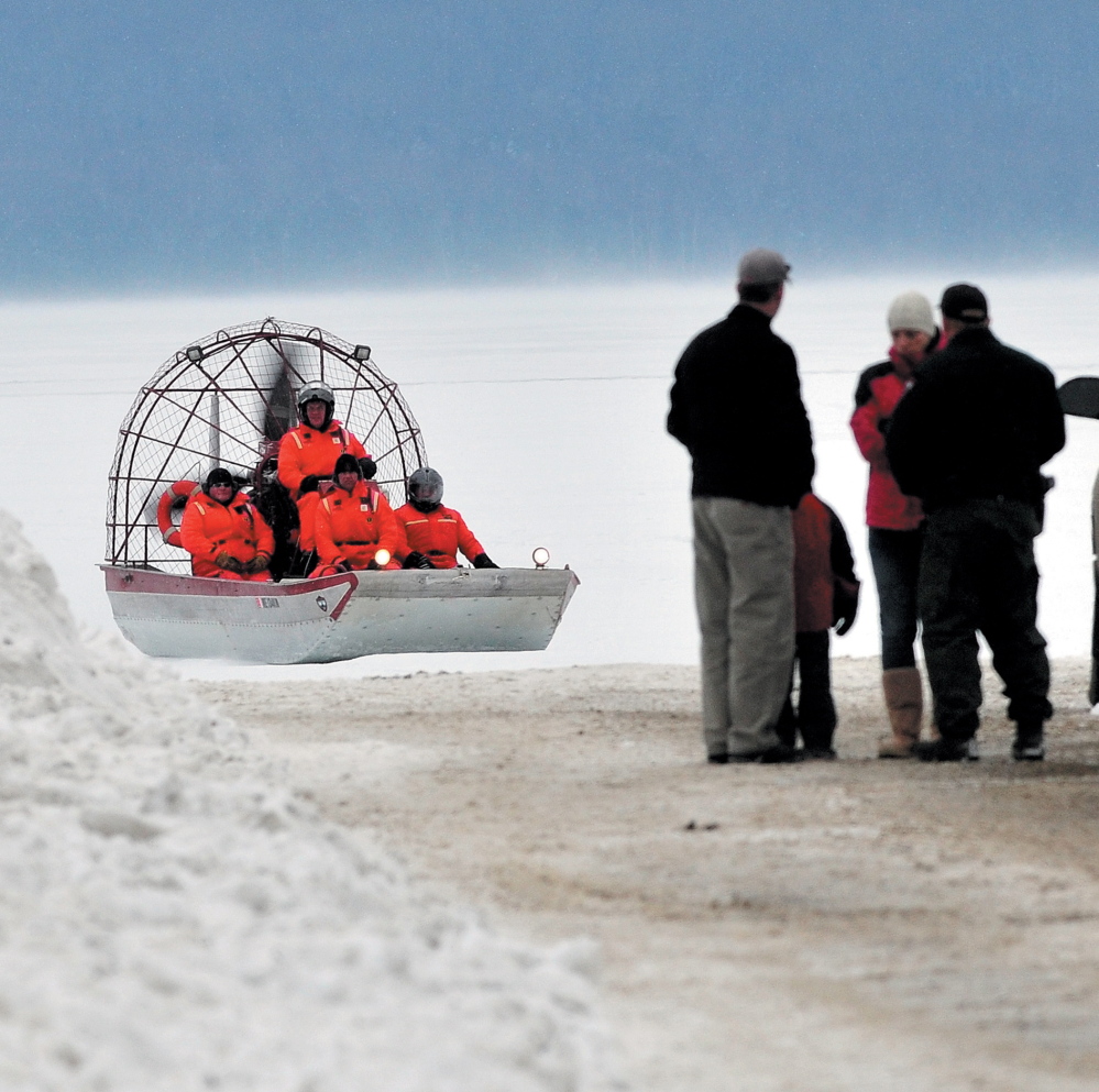 Maine Warden Service personnel return to shore in an airboat on Rangeley Lake in Rangeley after motoring over ice to the location where the snowmobile that Dawn Newell was riding broke through the ice in December 2012.