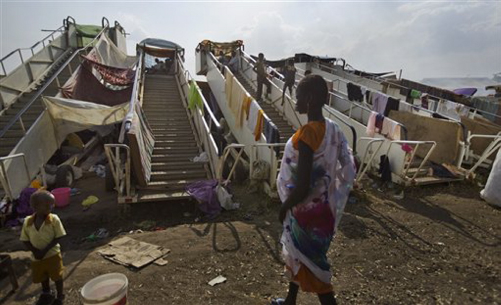 Moveable stairs used for passengers to board aircraft are repurposed into makeshift shelters by the displaced at a United Nations compound which has become home to thousands of people displaced by the recent fighting, in the capital Juba, South Sudan Sunday.