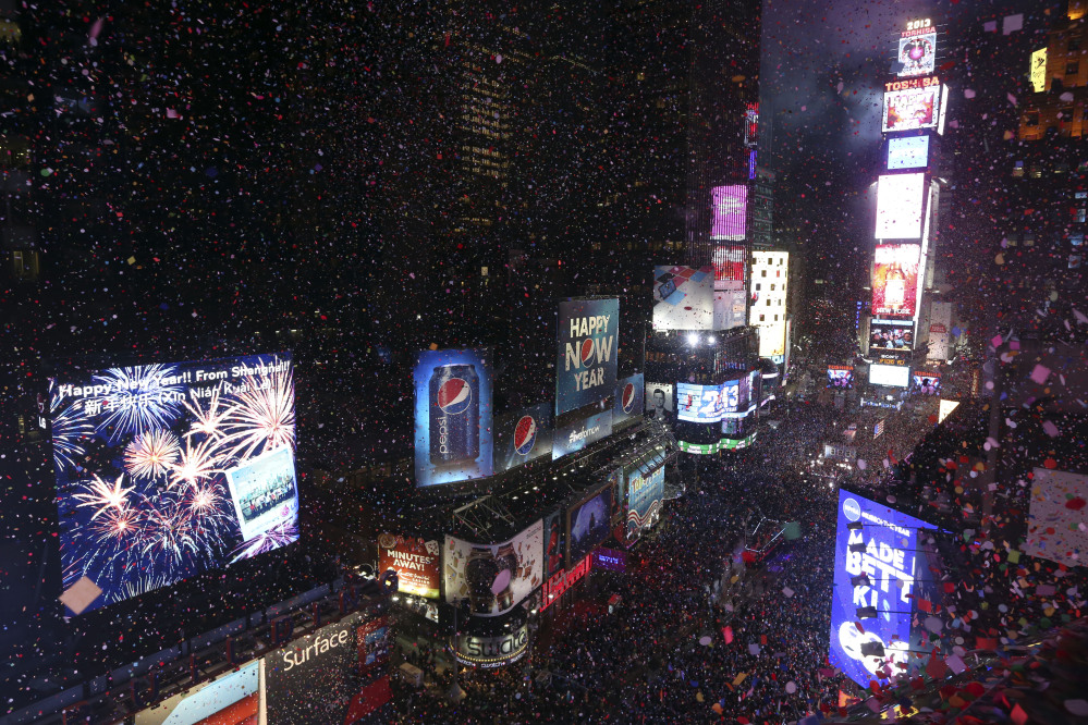 In this Jan. 1, 2013, file photo, donfetti flies over New York’s Times Square after the clock strikes midnight during the New Year’s Eve celebration as seen from the Marriott Marquis hotel in New York.