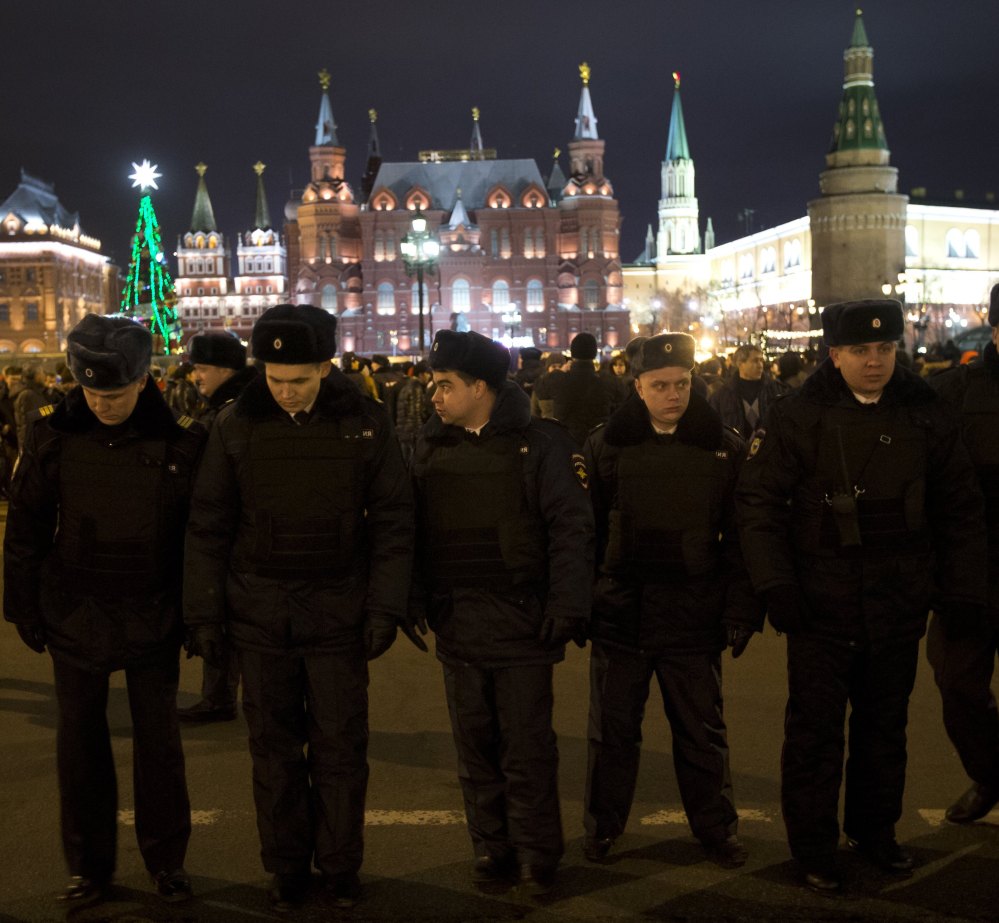 Russian police officers get ready to check people arriving at Red Square ahead of the New Year’s Eve festivities in Moscow on Tuesday.