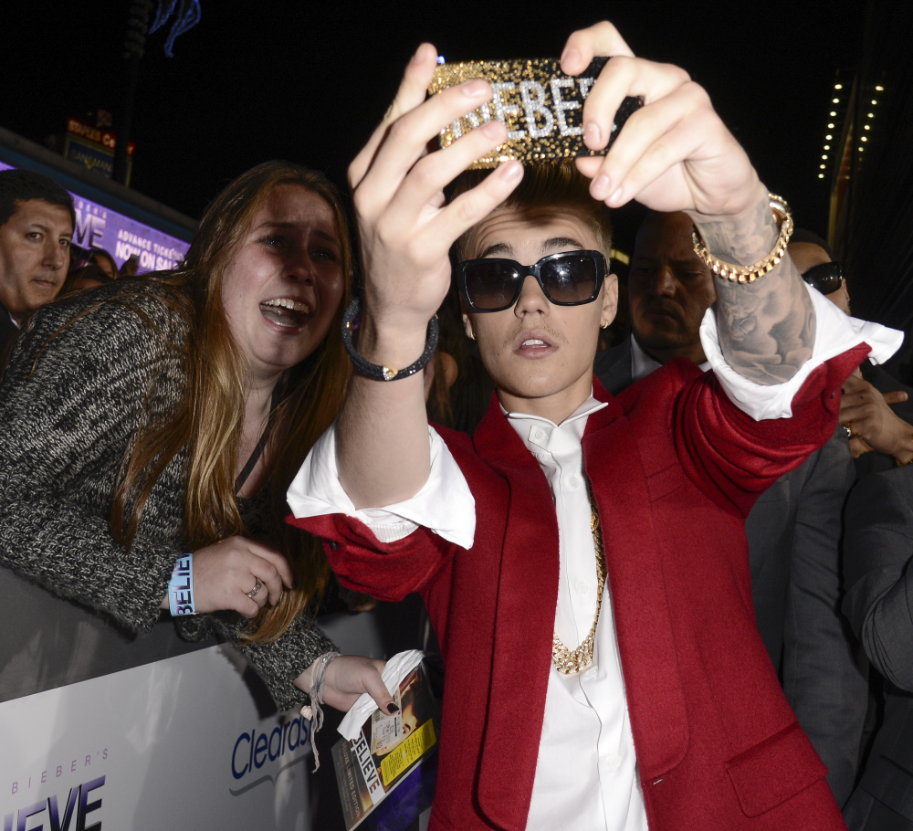 Singer Justin Bieber takes a “selfie” with a fan at the premiere of the feature film “Justin Bieber’s Believe” at Regal Cinemas L.A. Live in Los Angeles. The word selfie is on a list of among those words selected for elimination in Michigan’s Lake Superior State University’s 39th annual batch of words to banish due to overuse, overreliance and overall fatigue.