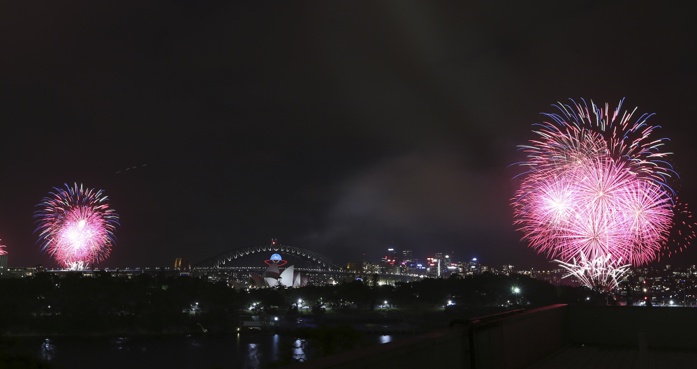 Fireworks explode near the Harbor Bridge and the Opera House during New Year’s Eve celebrations in Sydney, Australia, Tuesday, Dec. 31, 2013.