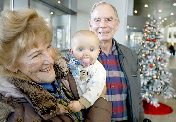 Manny Morgan of Cape Elizabeth holds her 7-month-old granddaughter Corinne Corbett at the Portland International Jetport while she and her husband, Chris Corbett, talk about the FCC moving to allow cellphone use during flights.