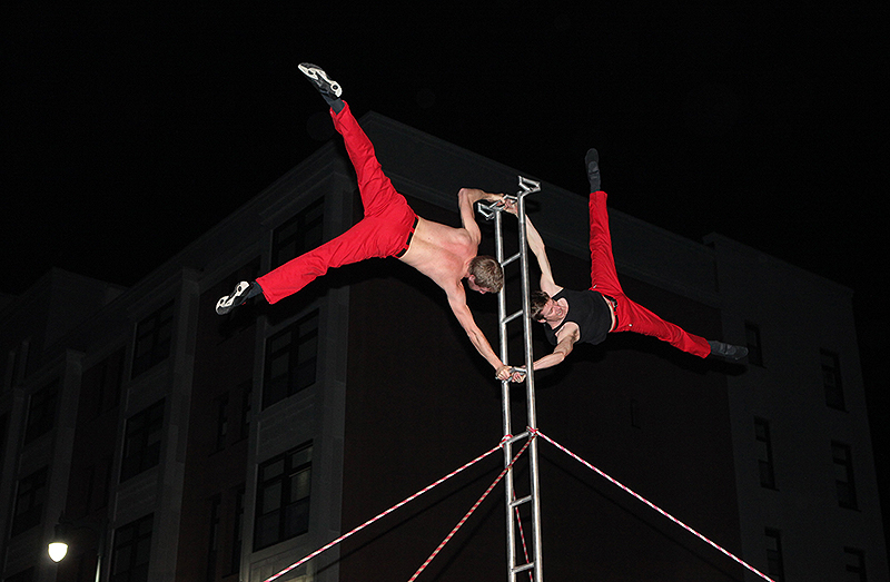 David Graham, left, and Tobin Remick balance on top of a ladder during the First Friday Art Walk on Congress Street.