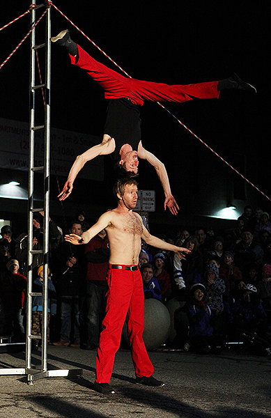 Tobin Remick balances on top of David Graham during a performance of the Red Trouser Show.