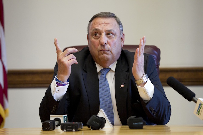 In this June 2013 file photo, Gov. Paul LePage speaks to reporters at the State House in Augusta. The LePage administration has proposed a rule change to prevent asylum seekers and some other immigrants from receiving General Assistance.