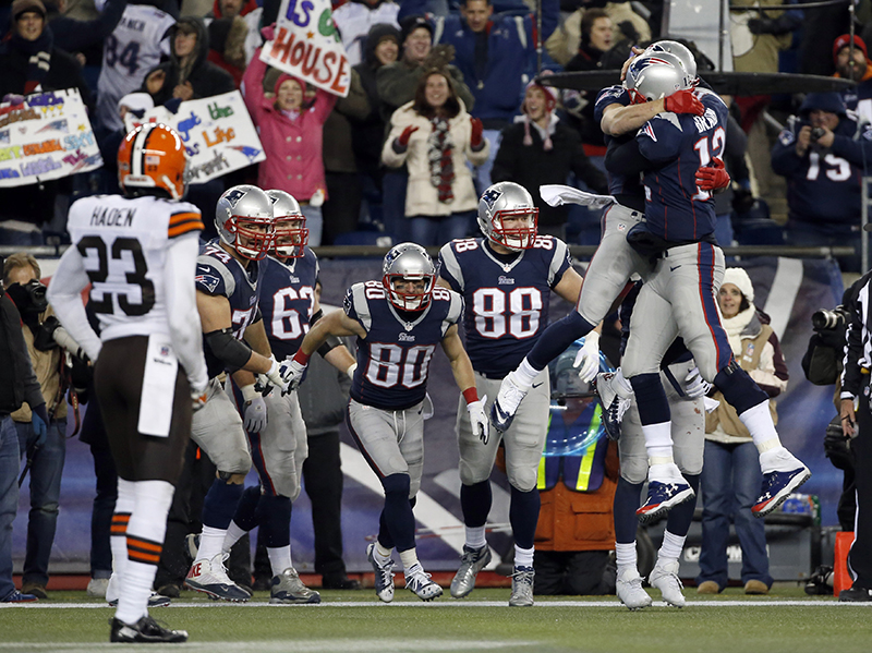 New England Patriots quarterback Tom Brady celebrates his go-ahead touchdown pass to wide receiver Danny Amendola (80) with Julian Edelman, hugging Brady, in the fourth quarter against the Cleveland Browns on Sunday in Foxborough, Mass. The Patriots came from behind to win 27-26.