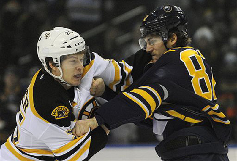Boston Bruins' Nick Fraser (25) gets locked up with Buffalo Sabres' Marcus Foligno (82) during a fight in the first period in Buffalo, N.Y., Thursday. Buffalo won 4-2.