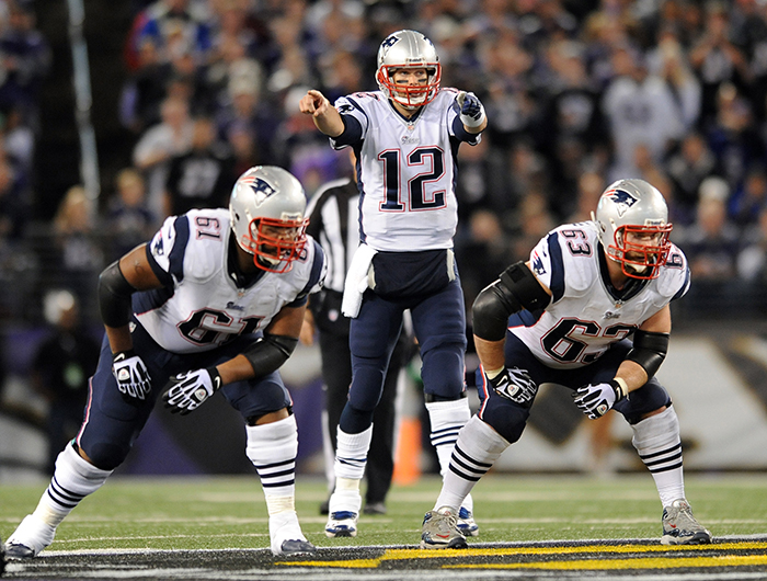 New England Patriots quarterback Tom Brady directs his teammates before running a play in the first half of Sunday's game against the Baltimore Ravens. The Patriots routed the Ravens, 41-7.