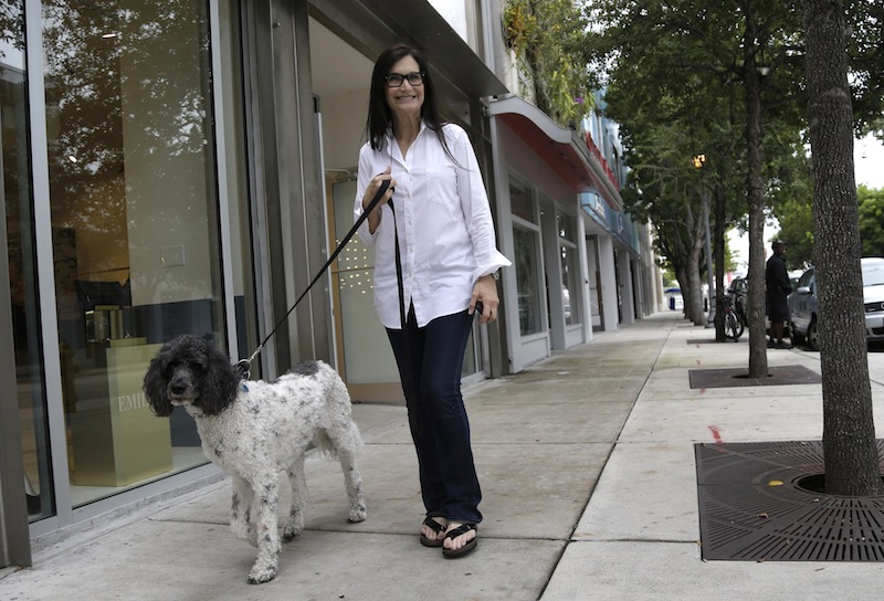 Gallery owner Deborah Sponder walks her dog in the Design District neighborhood of Miami. Fully 20 percent of U.S. adults become rich for parts of their lives, wielding outsized influence on America's economy and politics.