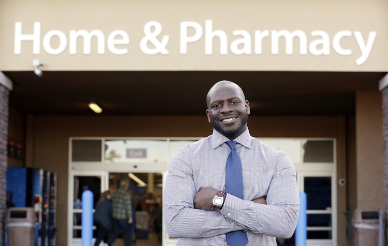 James Lott stands outside the Walmart store where he works as a pharmacist in Bonney Lake, Wash. Lott, who lives in Renton, Wash., a suburb of Seattle, adds significantly to his six-figure job salary by day-trading stocks.