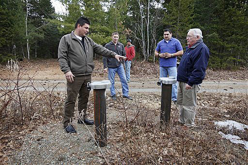 Michael Dugay, a consultant for the Passamaquoddy tribe, left, and Chief Joseph Socobasin lead a group visiting a spring water well site on tribal land in Indian Township. The tribe is planning to build a bottling plant with the goal of bottling 10 million cases of water by the third year of operation.