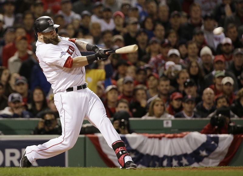 Mike Napoli hits a double that scored three runs in the first inning of Game 1 of the World Series against the St. Louis Cardinals. Napoli has re-signed with the Red Sox.