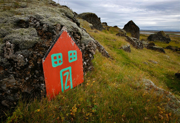 An elf door leans against a rock in the Icelandic countryside outside the village of Selfoss. Belief in the unseen runs so high in Iceland that the Public Roads Administration sometimes delays or reroutes road construction to avoid what locals believe are elf habitations or cursed spots.