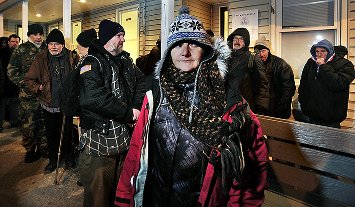 Laurel Merchant stands in line in the cold with dozens of others as they wait to get in to the Oxford Street Shelter for the night. Friday, December 13, 2013. Gordon Chibroski, Staff Photographer