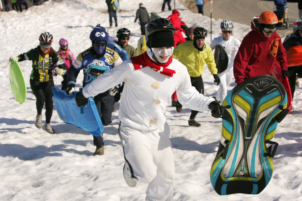 Justin McClogan and other participants dash up the Portland's the hill of Portland's Eastern Promanade during the first leg of the 2011 Snowman Adventure Race.