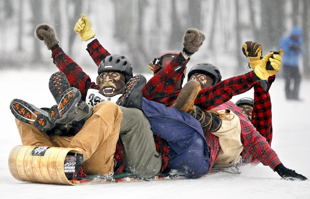 Members of team Fetching Yetis celebrate a successful run during the 22nd annual U.S. National Toboggan Championships at the Camden Snow Bowl in 2012.