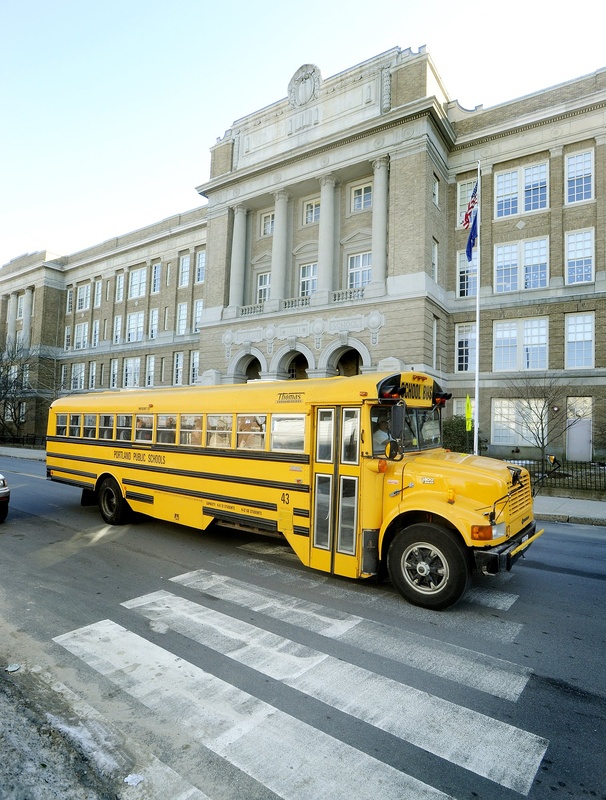 A school bus passes by Portland High School.