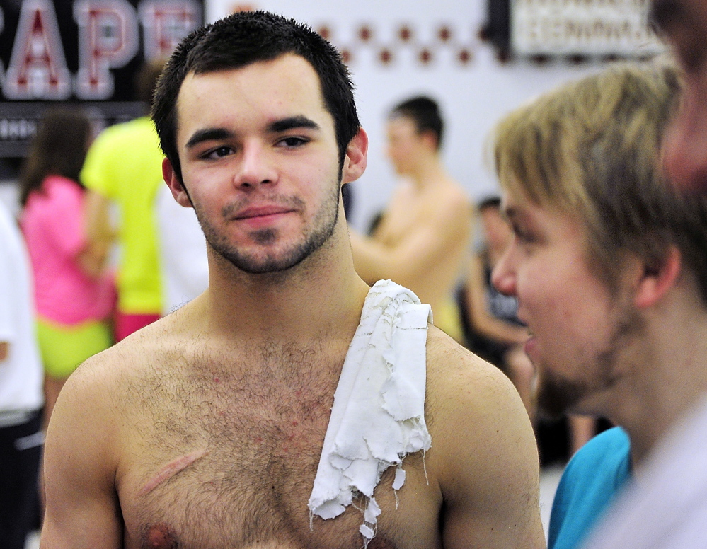Cheverus senior Nick Jensen talks with friends after winning the diving event in December at the Southwesterns North boys’ swim championships at Cape Elizabeth High School .