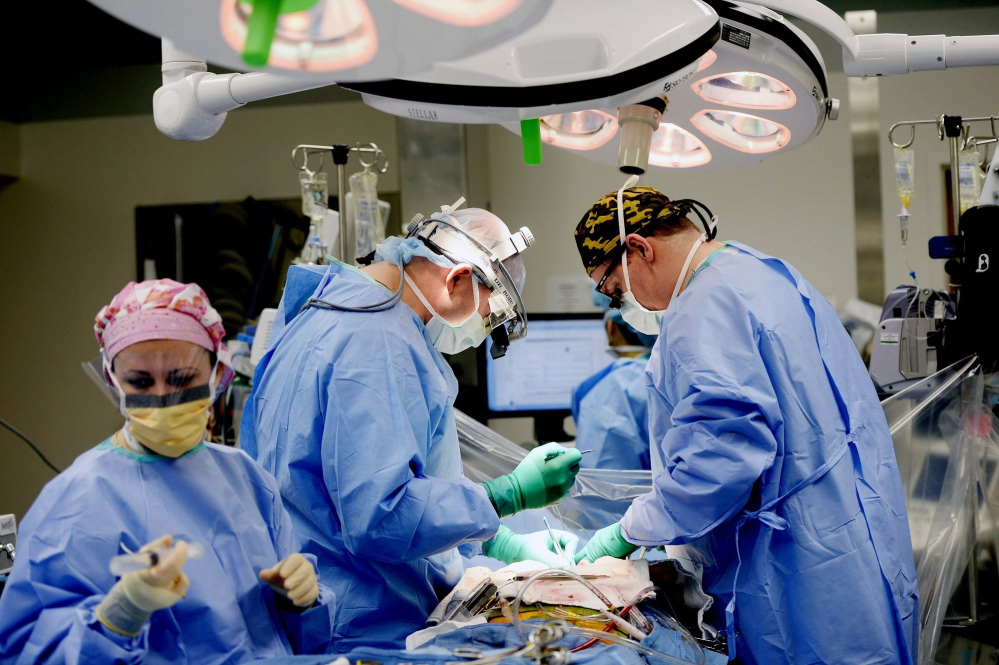 A medical team performs surgery at Maine Medical Center in Portland this month.