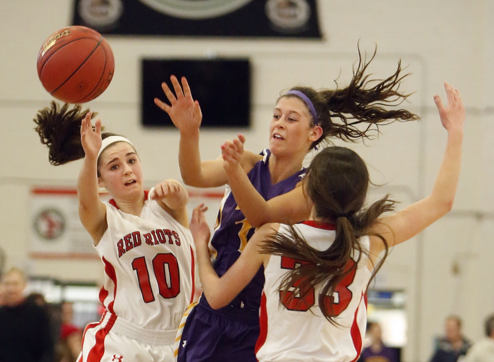 Jill Libby of Cheverus tries to thread the ball through Lydia Henderson, left, and Maddie Hasson of South Portland during their Western Class A girls’ basketball quarterfinal Monday afternoon at the Portland Expo. Cheverus won, 61-42.