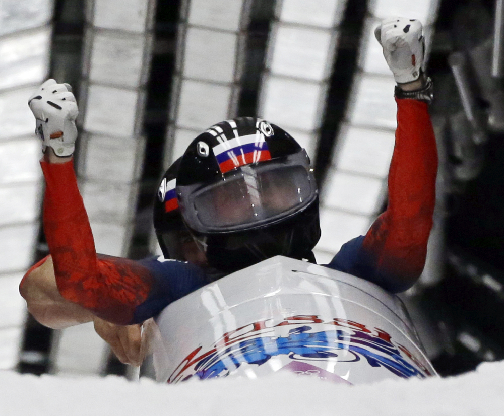 The Associated Press The team from Russia RUS-1, piloted by Alexander Zubkov and brakeman Alexey Voevoda, cross into the finish area to win the gold medal during the men’s two-man bobsled competition at the 2014 Winter Olympics on Monday in Krasnaya Polyana, Russia.