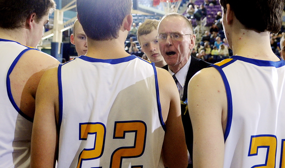Boothbay Region coach I.J. Pinkham speaks with his players during a tournament basketball match up Monday against Hall-Dale High School in Augusta.