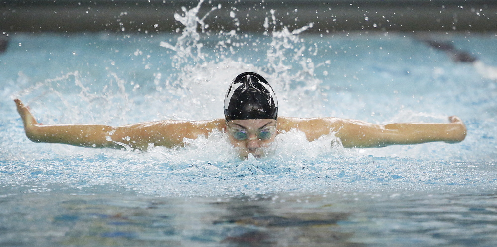 Colby Harvey of Waynflete heads toward a meet record of 54.97 seconds in the 100-yard butterfly Monday at the Class B girls’ swimming and diving championships at Bowdoin College.
