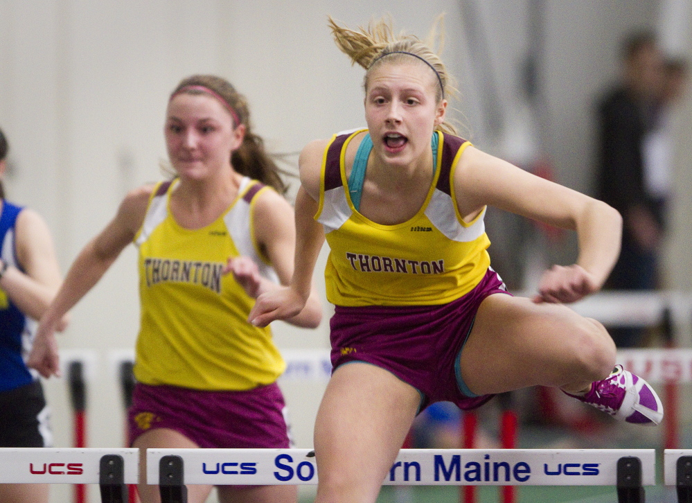 Tori Daigle of Thornton Academy clears a hurdles on her way to victory in the 55-meter hurdles Monday at the Class A indoor track and field championships. Daigle also set a meet record in the long jump, helping the Trojans earn the team title.